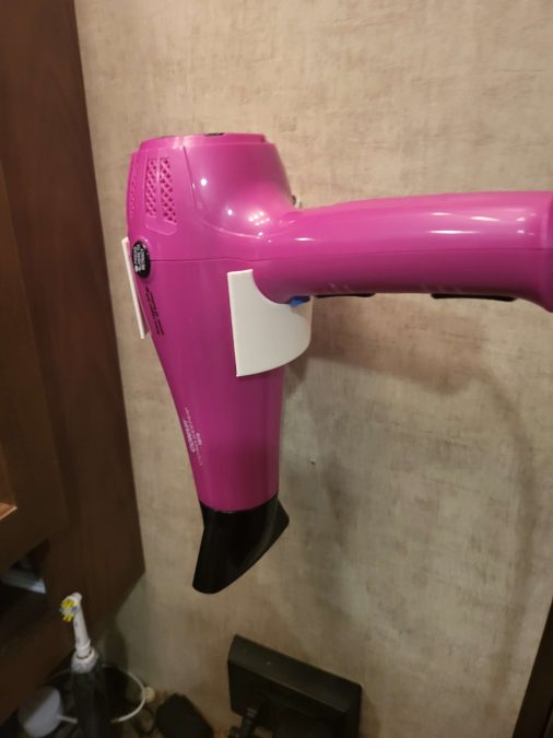 Wall mount for a Conair Cordkeeper style hairdryer.  Will work with most cone style simple models